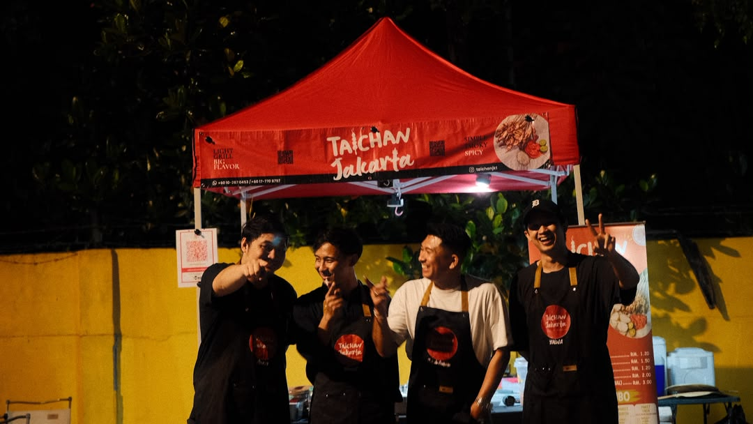 Taichan Jakarta crew posing under the red tent